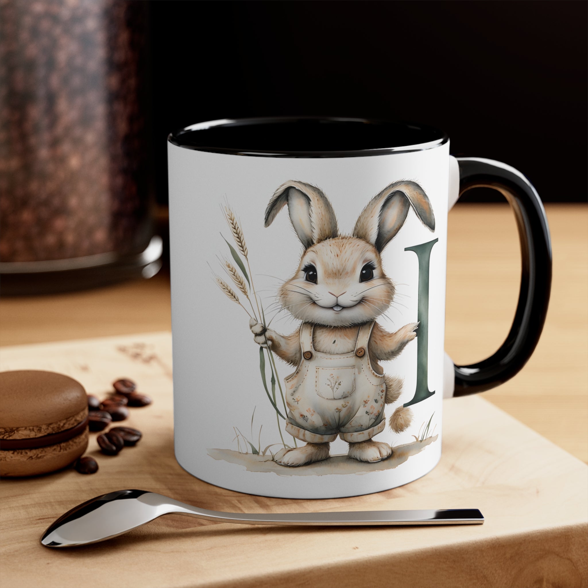 White mug with black handle/interior, bunny illustration and letter I accent