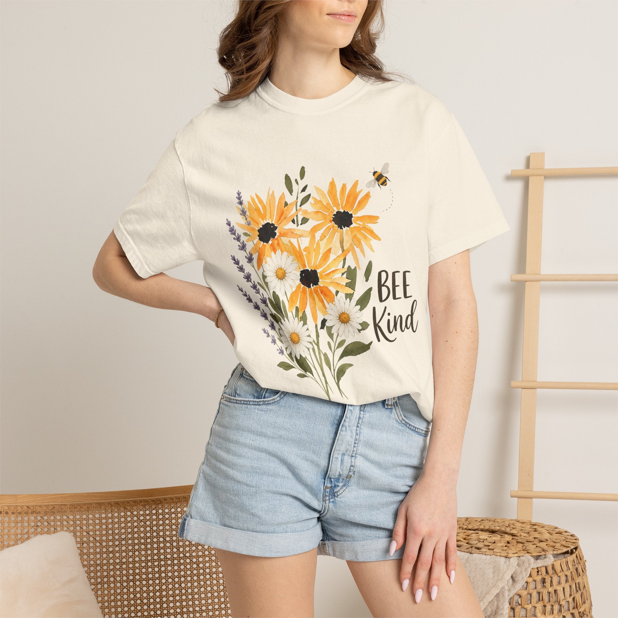 Ivory t-shirt on model with sunflower and lavender bouquet graphic and 'Bee Kind' text