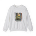 Light gray crewneck sweatshirt with centered film-strip graphic and text