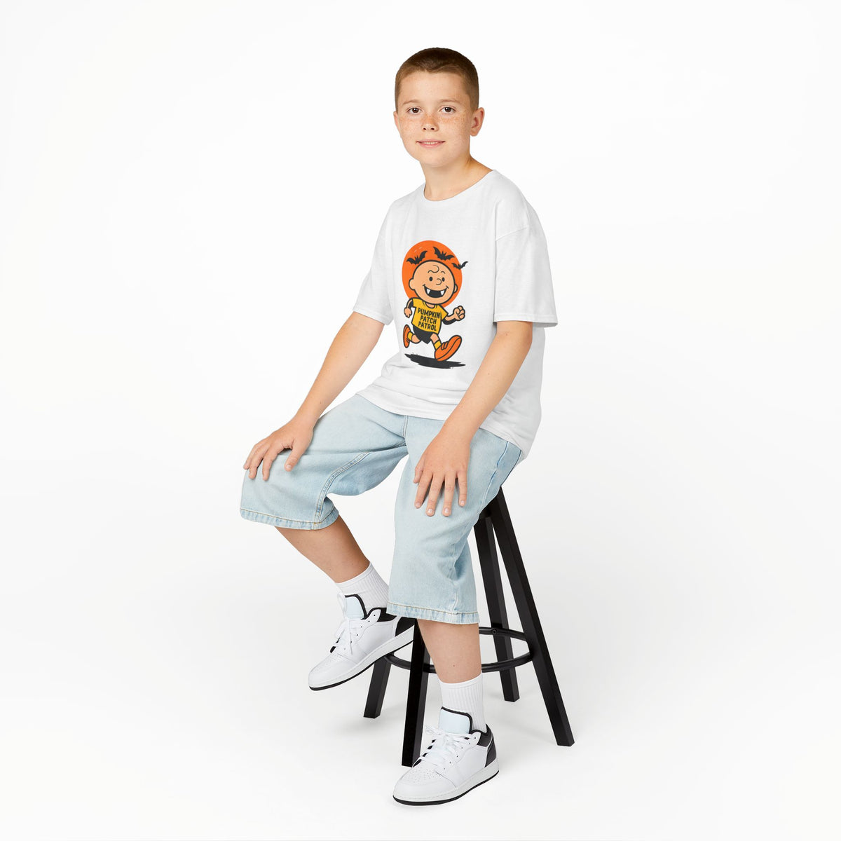 White kids pumpkin patrol T-shirt worn with denim shorts and white sneakers