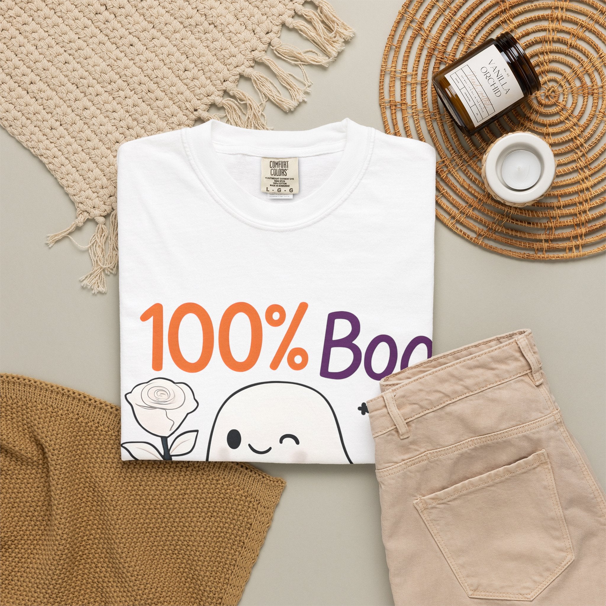 White Halloween graphic t-shirt laid flat, showing “100% Boo” ghost