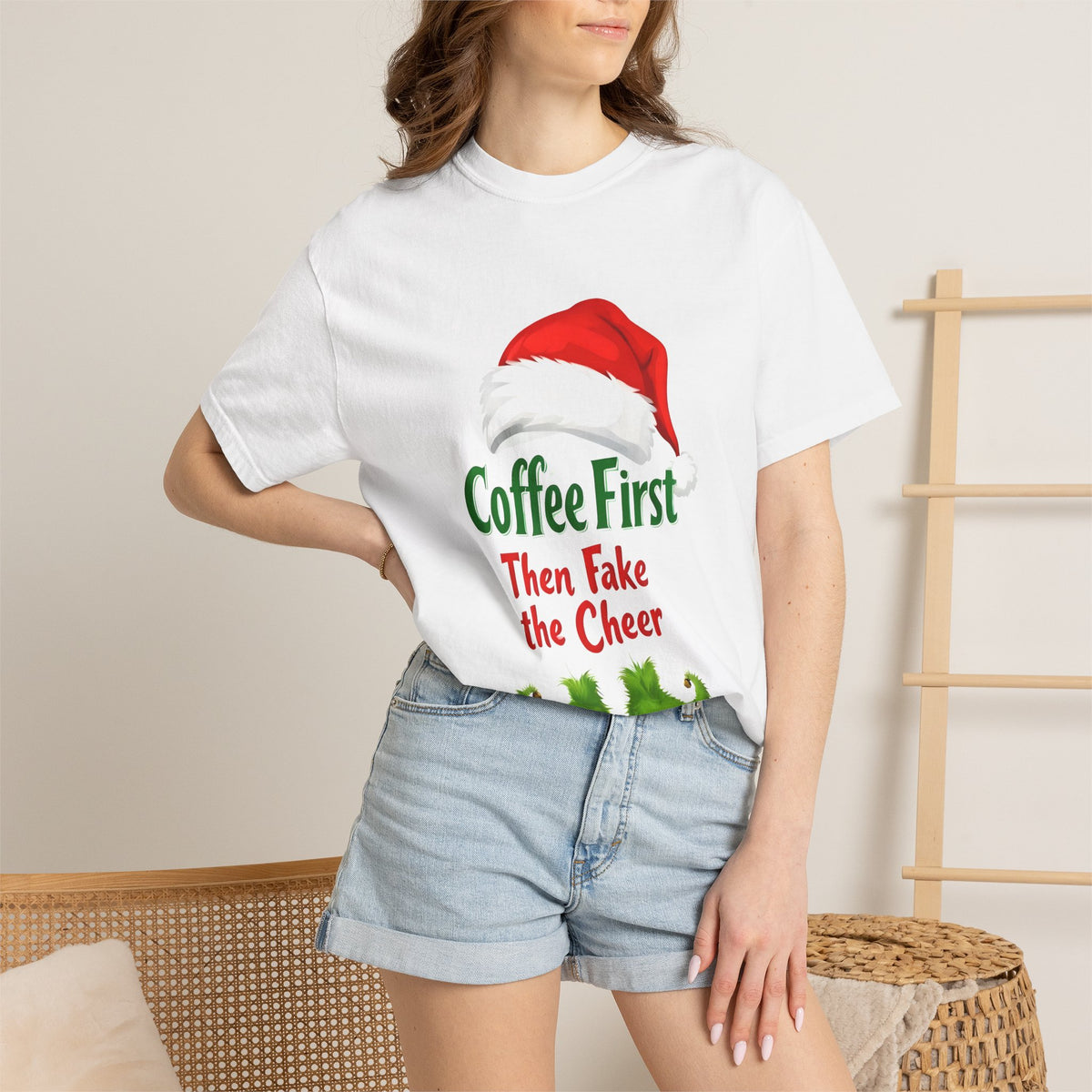 White unisex Christmas T-shirt worn, featuring Santa hat 'Coffee First' and 'Then Fake the Cheer'