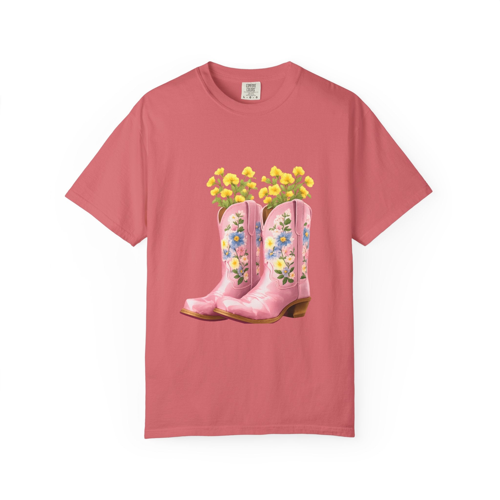 Coral crew-neck T-shirt with floral cowboy boot graphic and yellow flowers at top.