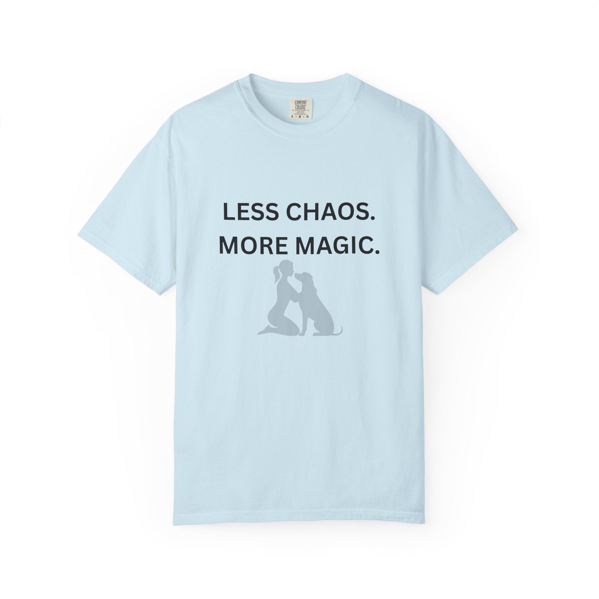 Light blue crew-neck T-shirt with 'LESS CHAOS. MORE MAGIC.' text and woman-dog silhouette