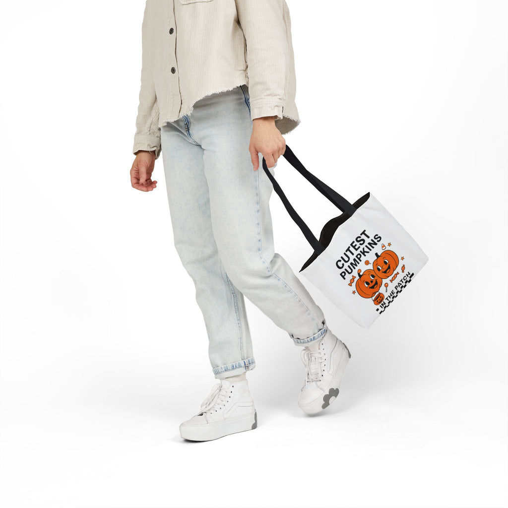 White canvas tote bag with black strap handles and 'CUTEST PUMPKINS' pumpkin graphic.