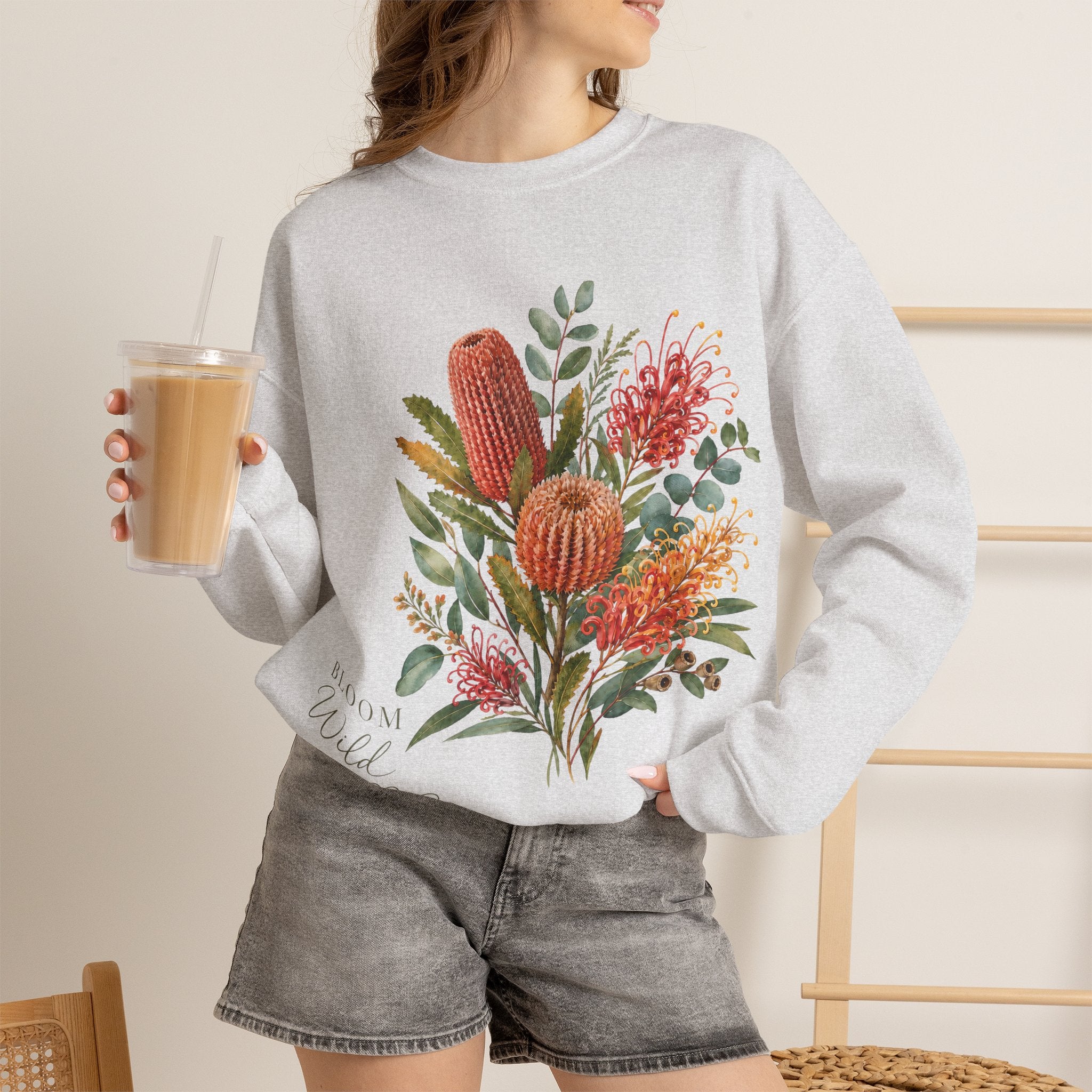 Ash gray crewneck sweatshirt with cactus floral print, worn long sleeves