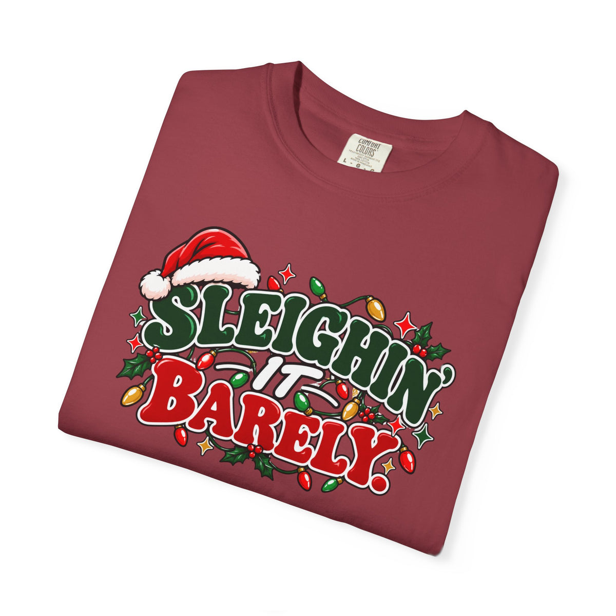 Burgundy crewneck t-shirt with large "Sleighin' It Barely" holiday graphic, angled