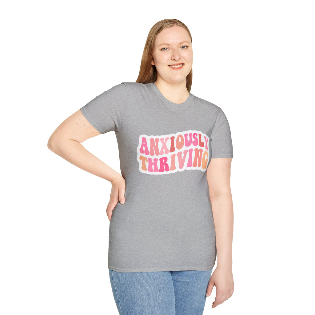 Unisex softstyle t-shirt heather gray on model with “ANXIOUSLY THRIVING” chest print