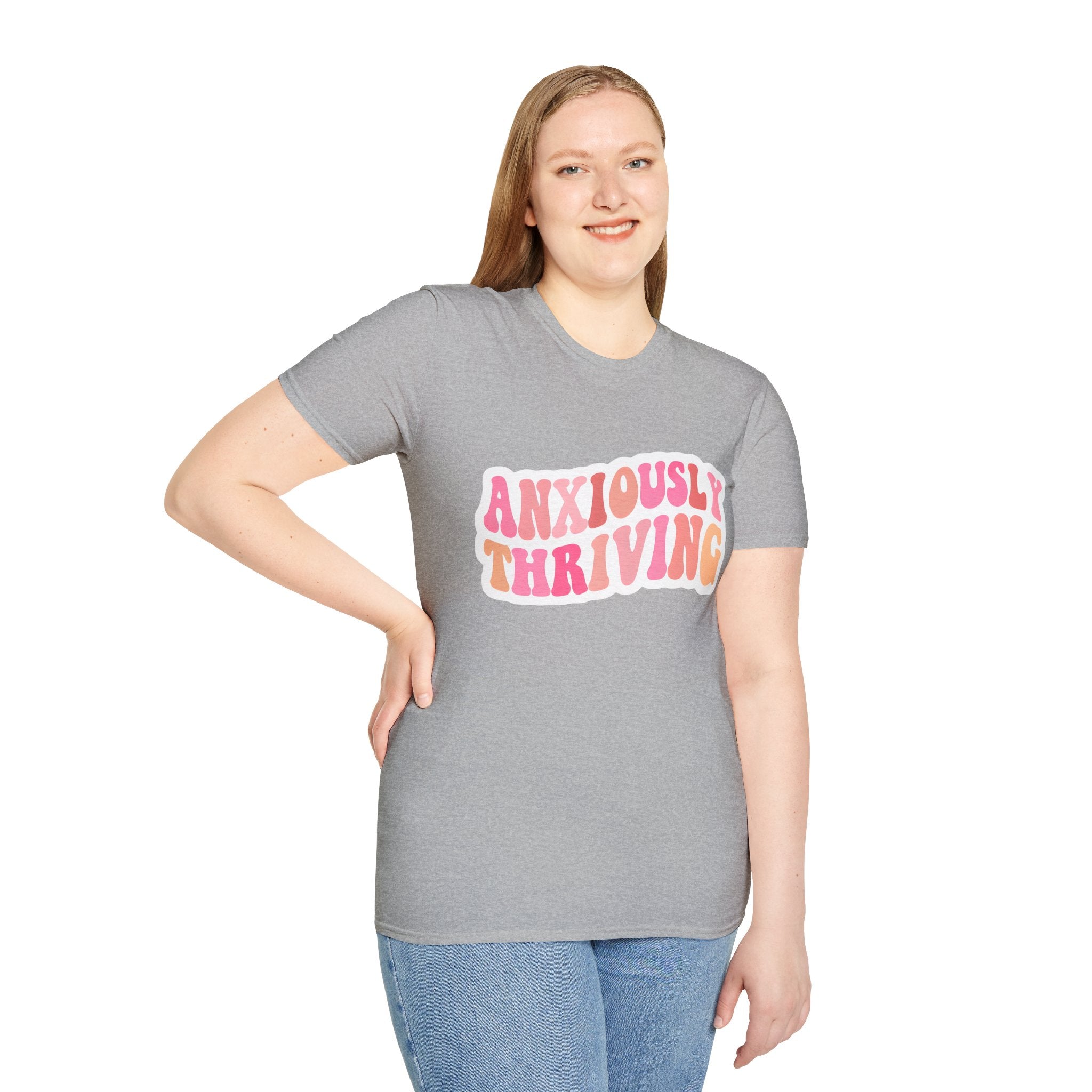 Unisex softstyle t-shirt heather gray on model with “ANXIOUSLY THRIVING” chest print