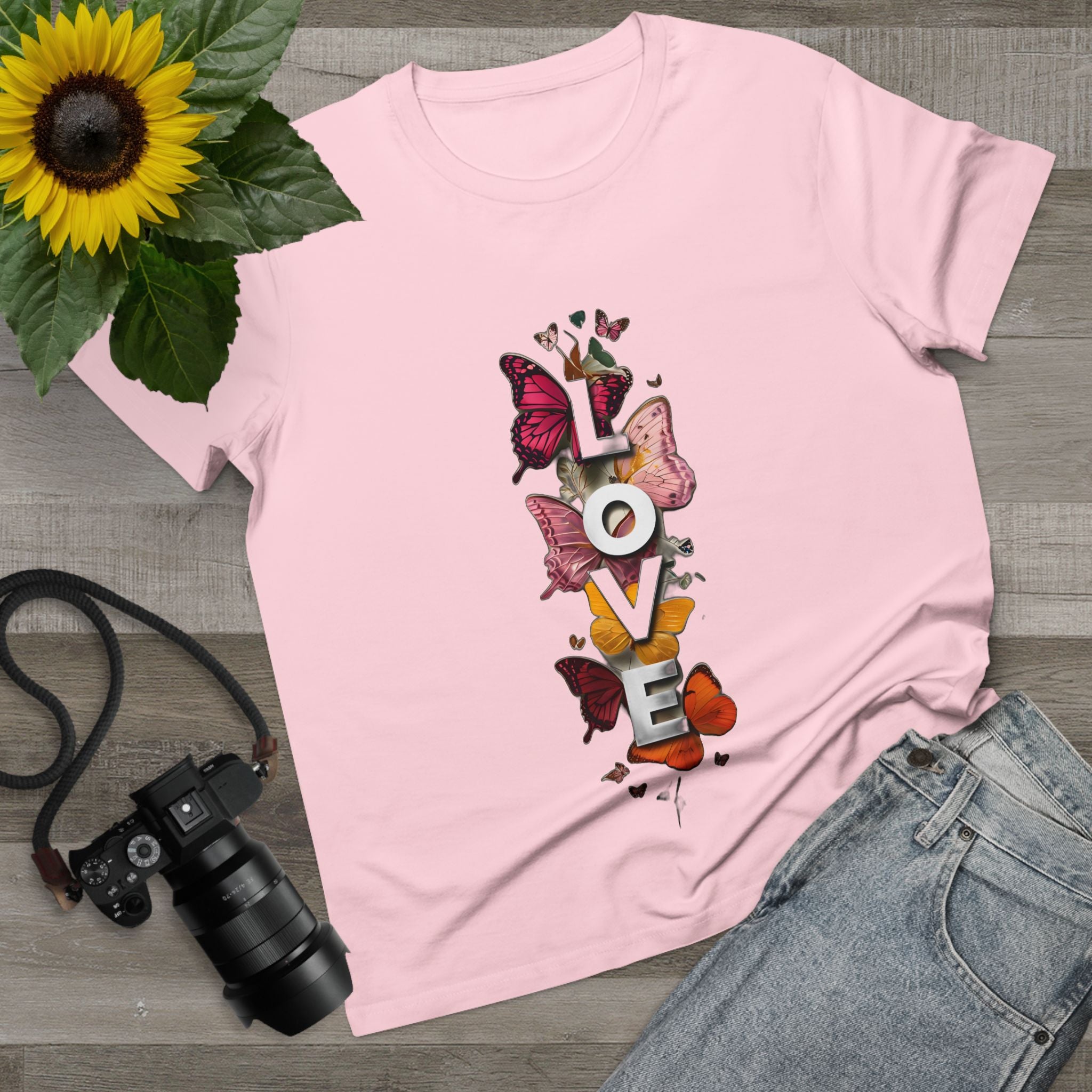 Pink women's graphic tee with centered LOVE letters and butterfly artwork.