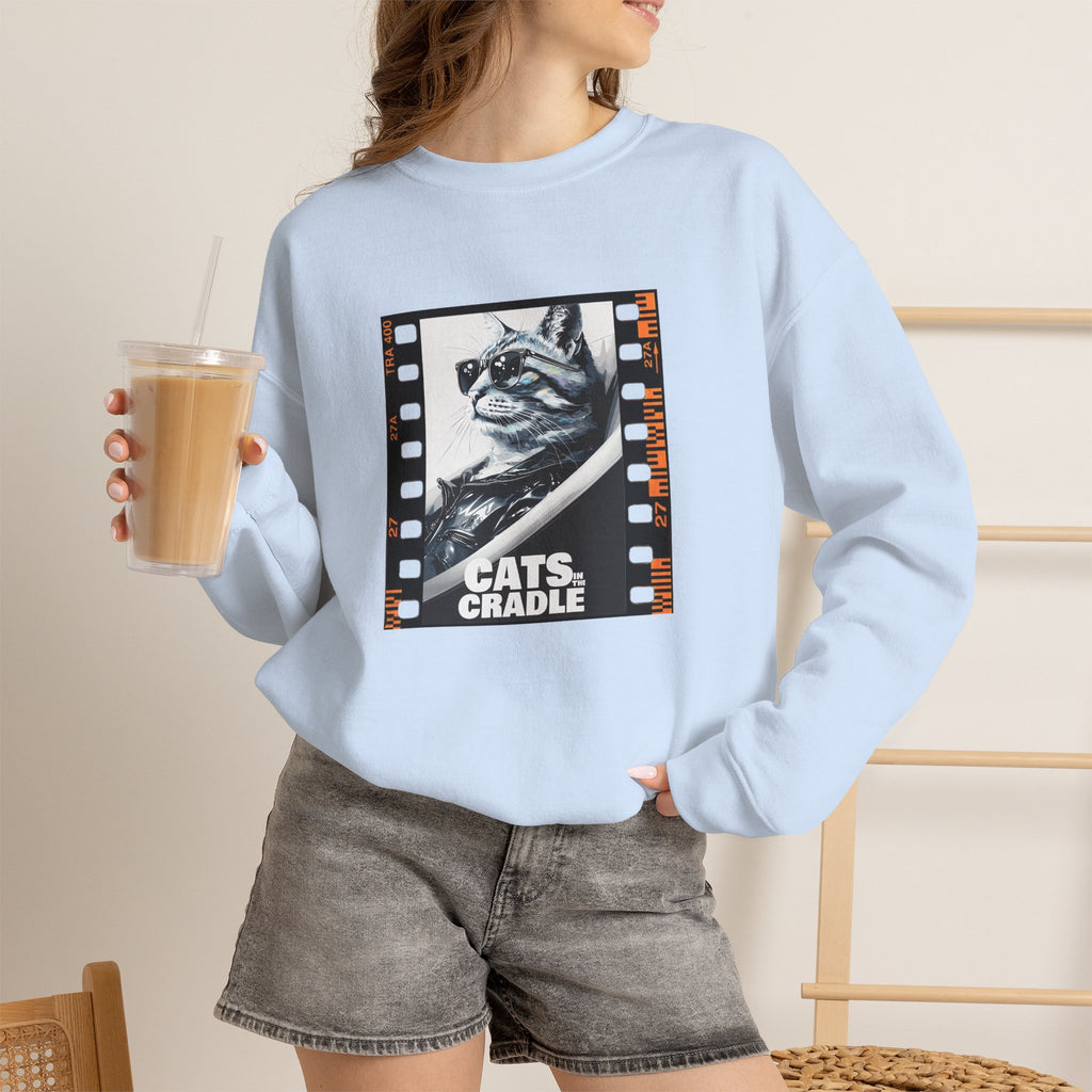 Light blue crewneck sweatshirt on model with cat filmstrip graphic on chest