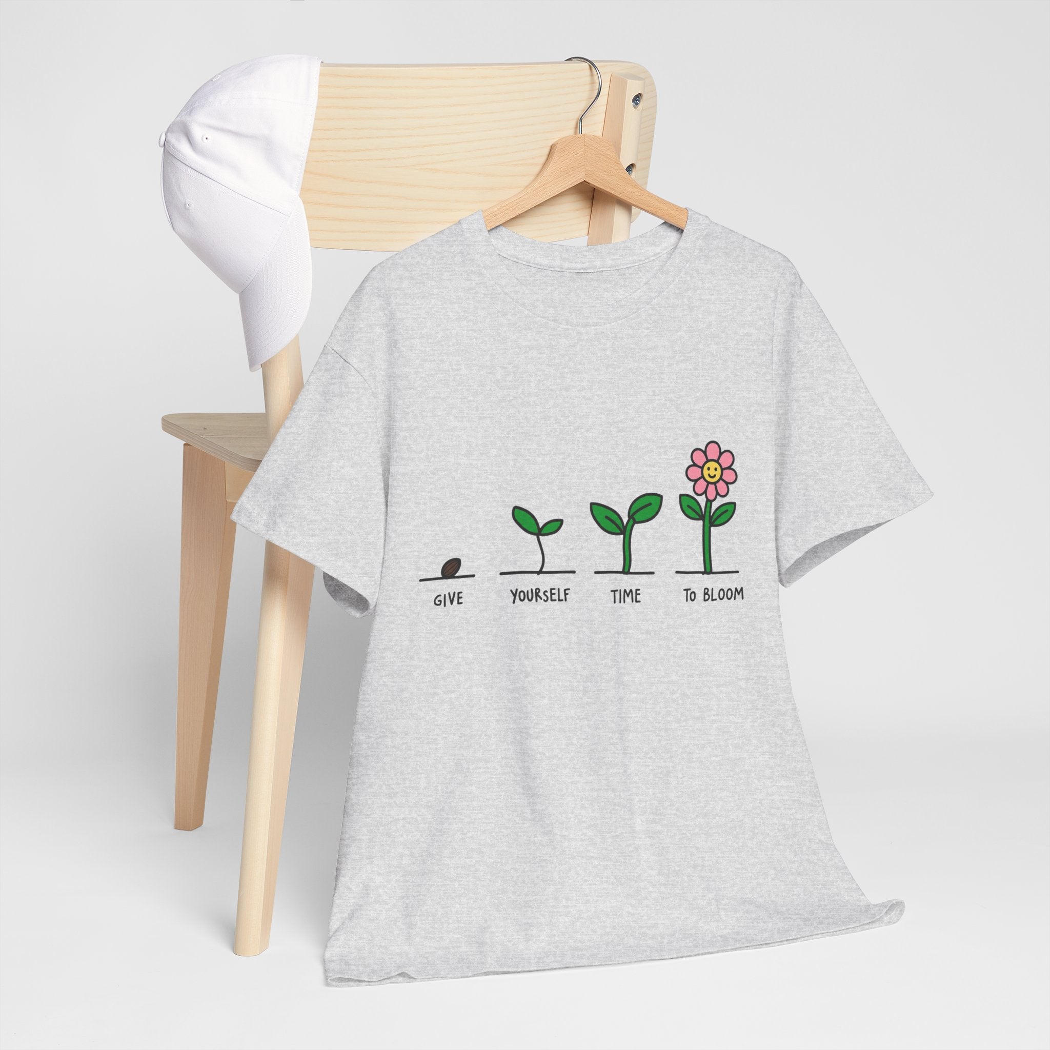Heather gray T-shirt with sprout-and-flower growth graphic, front view on hanger