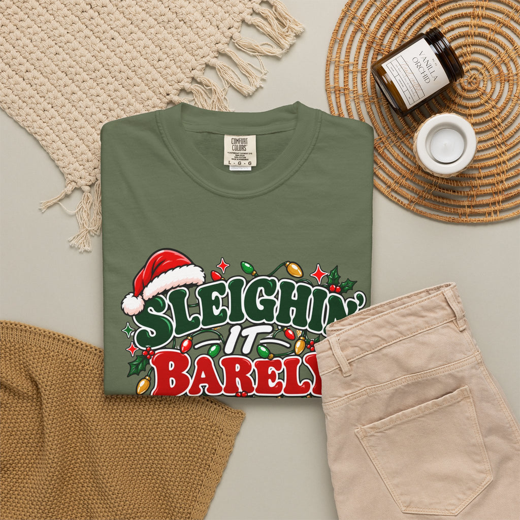 Olive green unisex crewneck Christmas graphic t-shirt with “Sleighin’ it Barely” front print