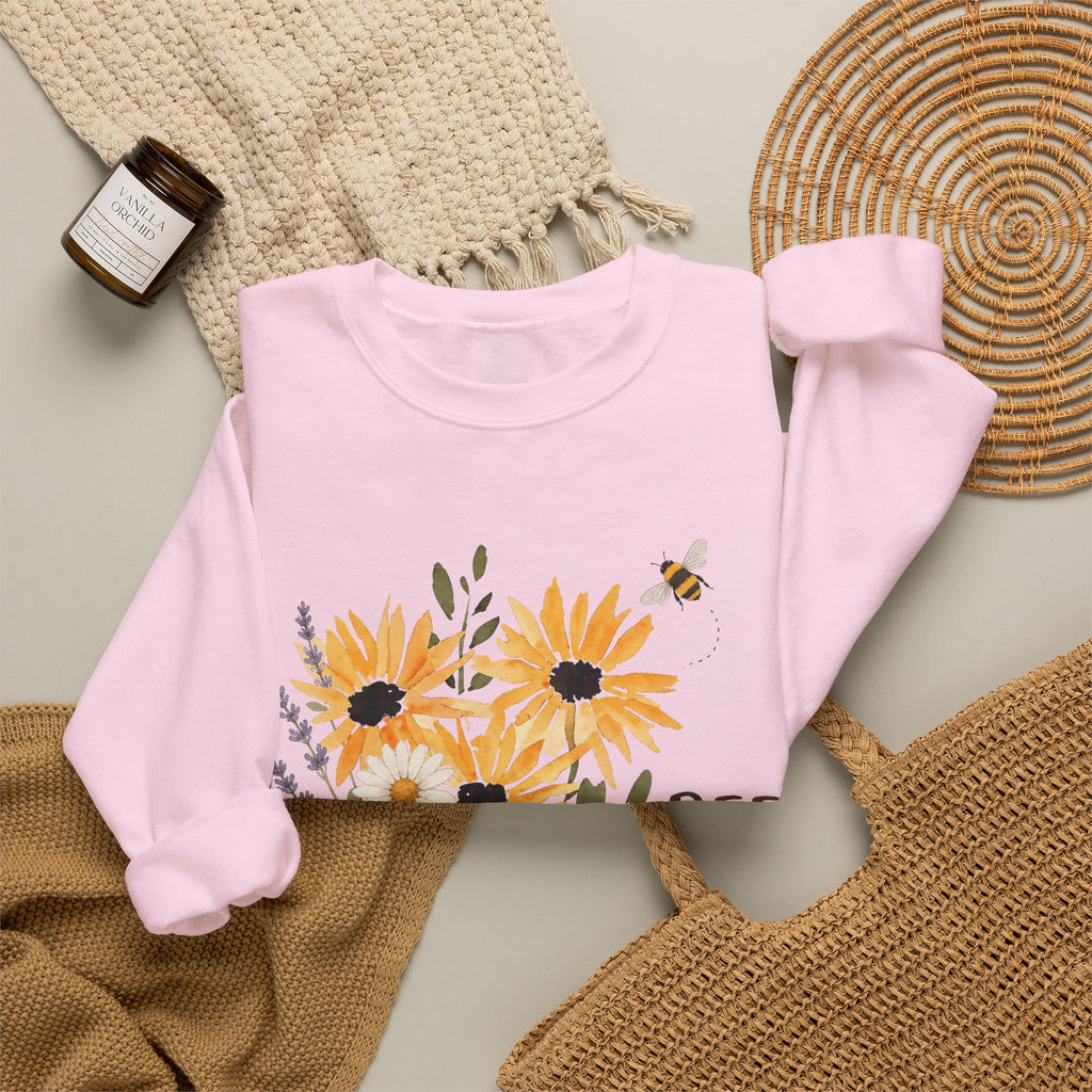 Light pink crewneck sweatshirt with sunflower bouquet print and bee details on front