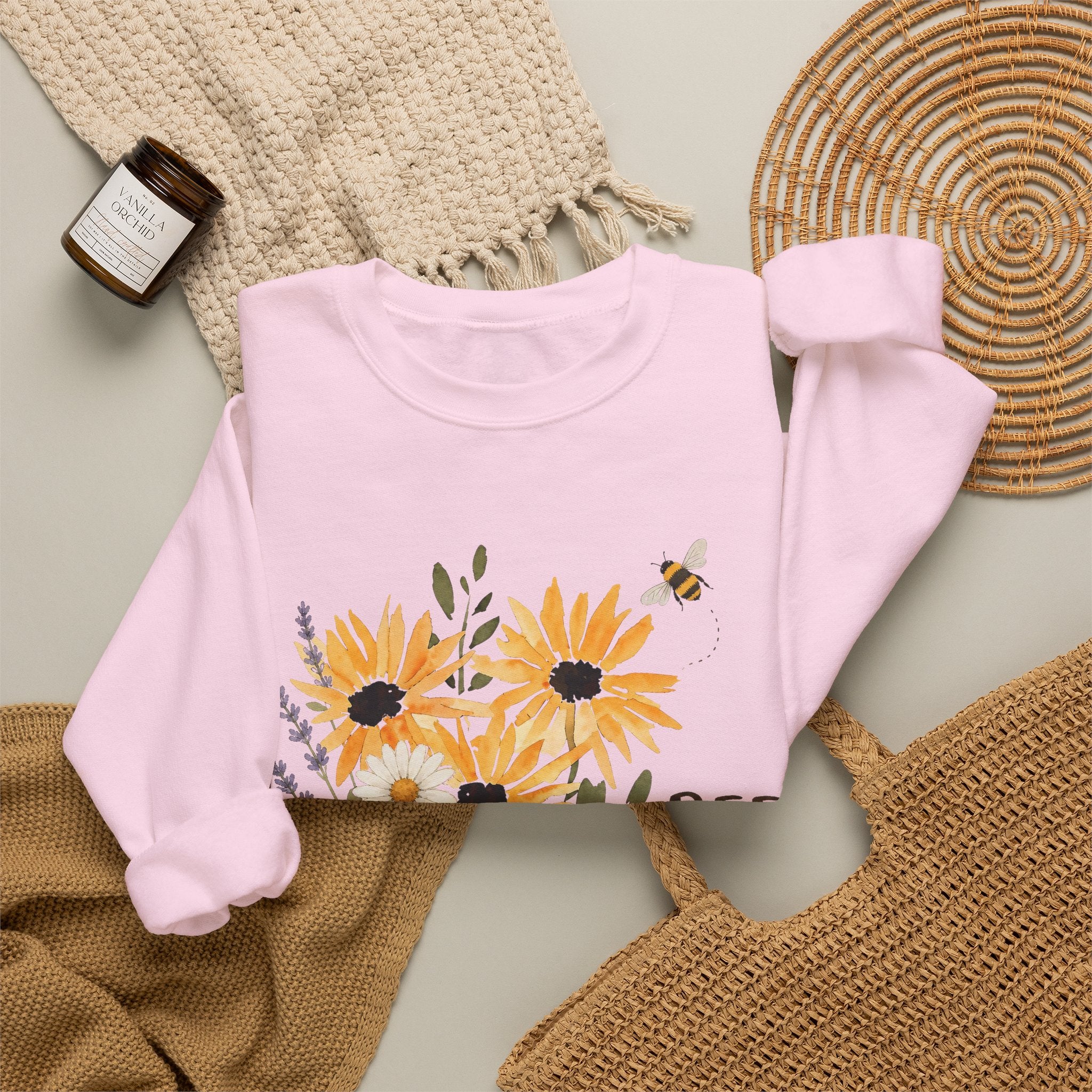Light pink crewneck sweatshirt with sunflower bouquet print and bee details on front