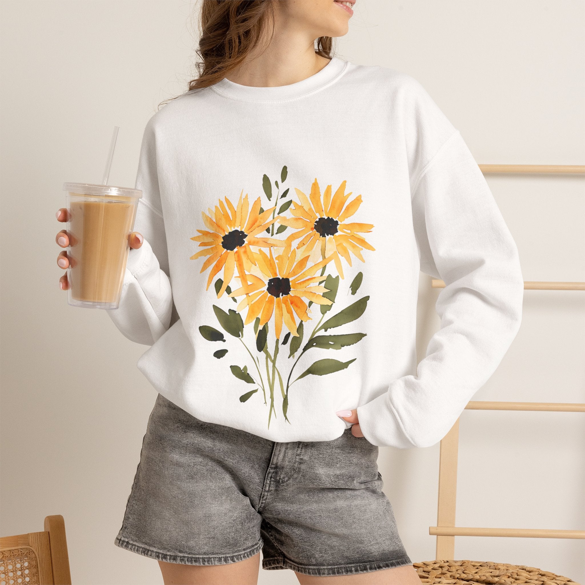 White crewneck sweatshirt worn by a model, featuring a sunflower bouquet front graphic