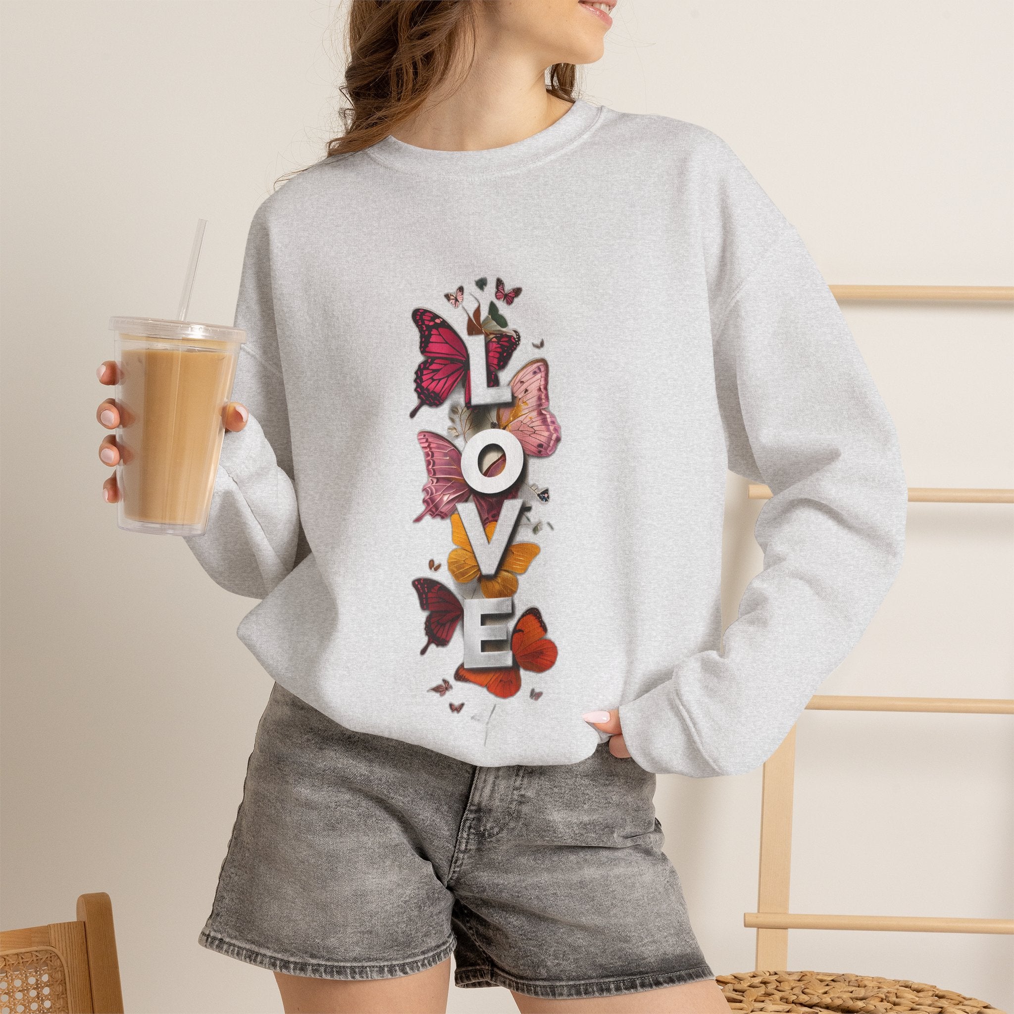 Ash gray crewneck sweatshirt with colorful butterfly “LOVE” graphic on front