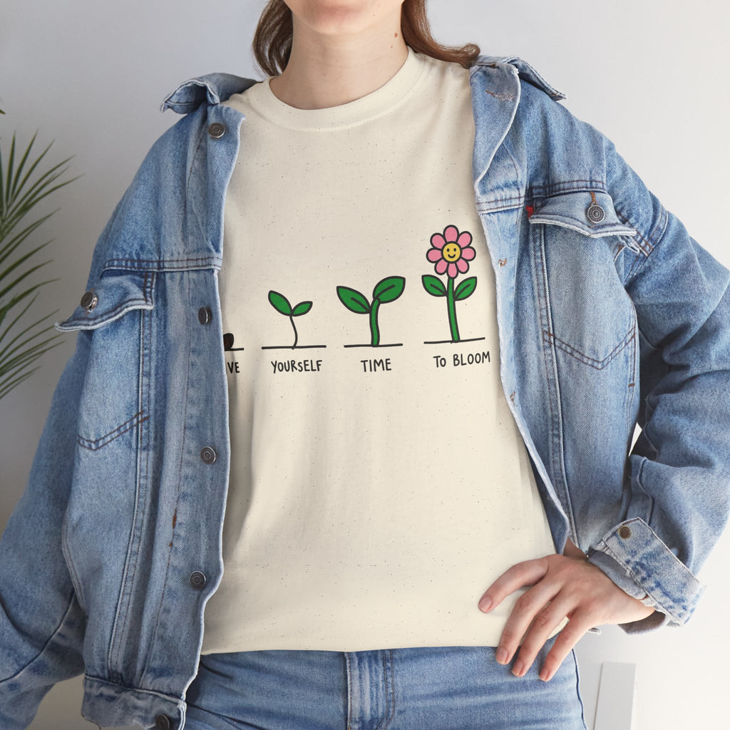Off-white graphic t-shirt with green plant growth line and pink flower print, worn by model