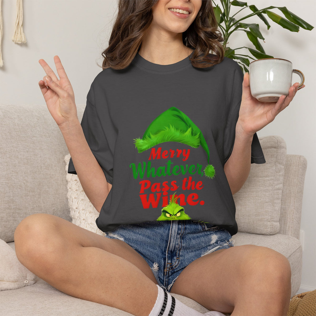 Graphite crewneck t-shirt with colorful holiday text and green hat graphic, worn.