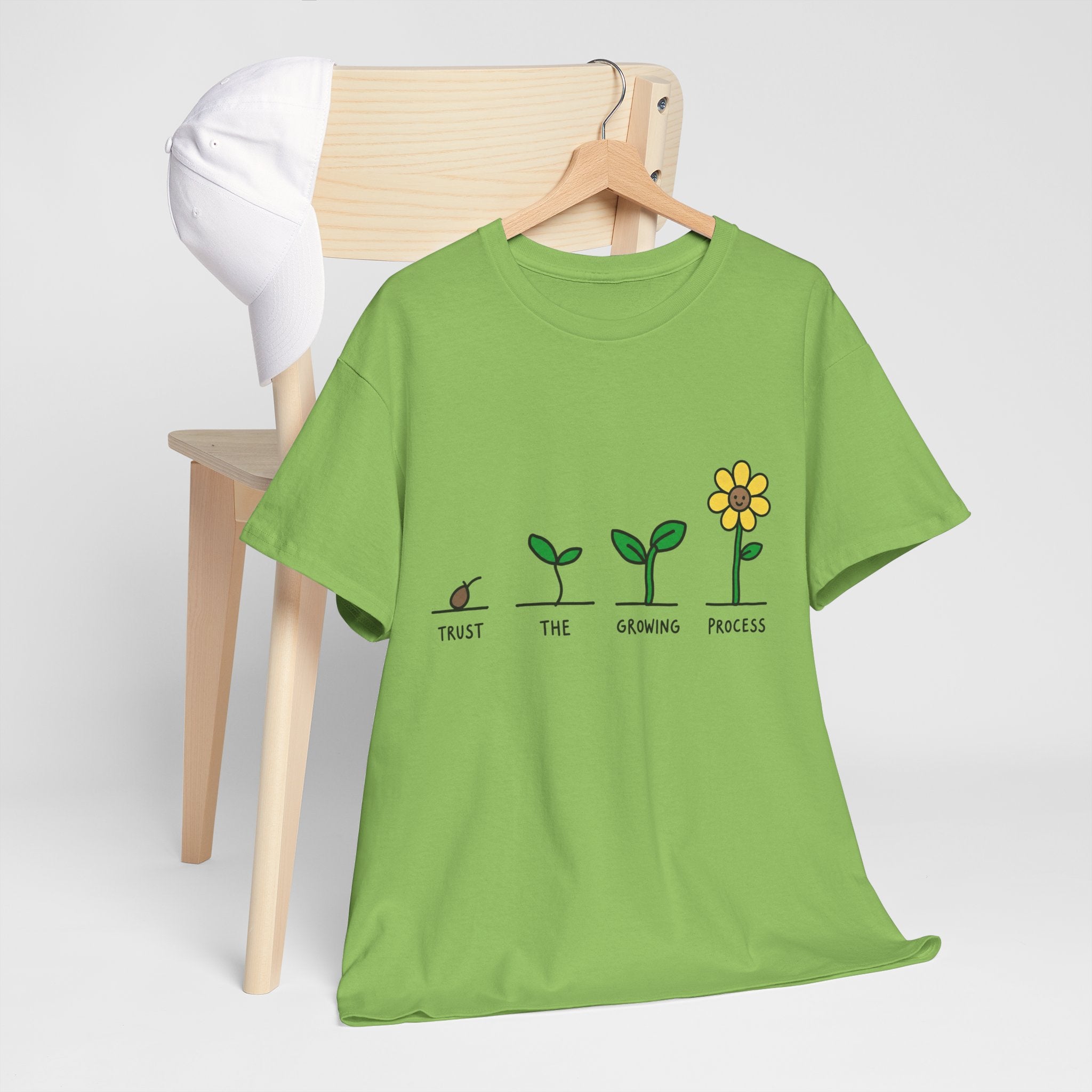 Green T-shirt with sprout-to-flower graphic and message text across the chest