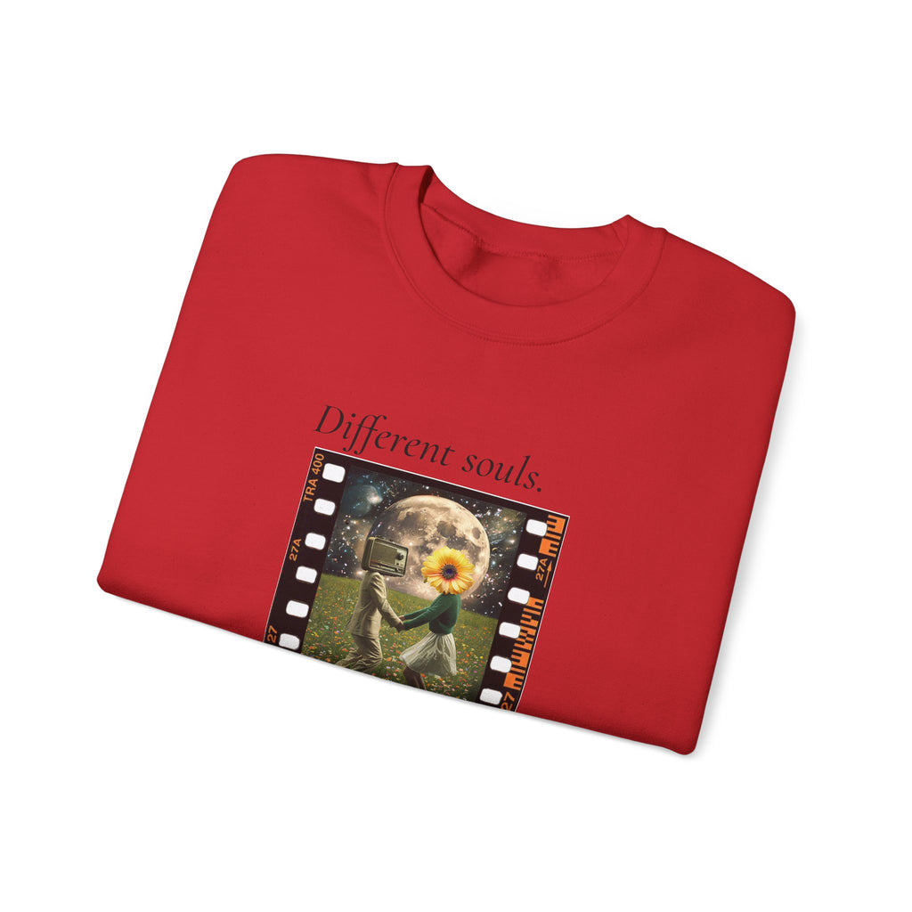 Red sweatshirt folded, showing chest graphic film-strip artwork and crew neckline
