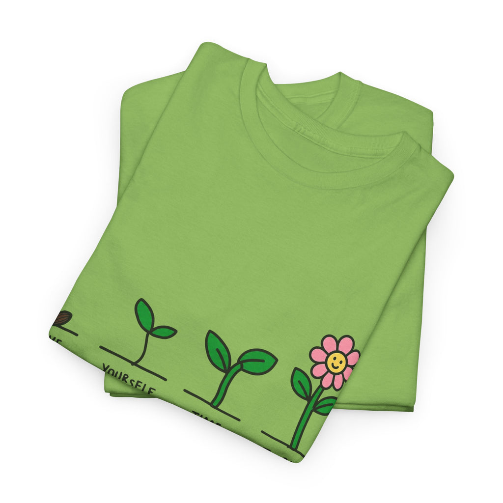 Green folded T-shirt with sprout-and-flower growth graphic and message text
