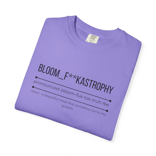 Purple graphic T-shirt with “BLOOM_F**KASTROPHY” slogan and small paragraph text