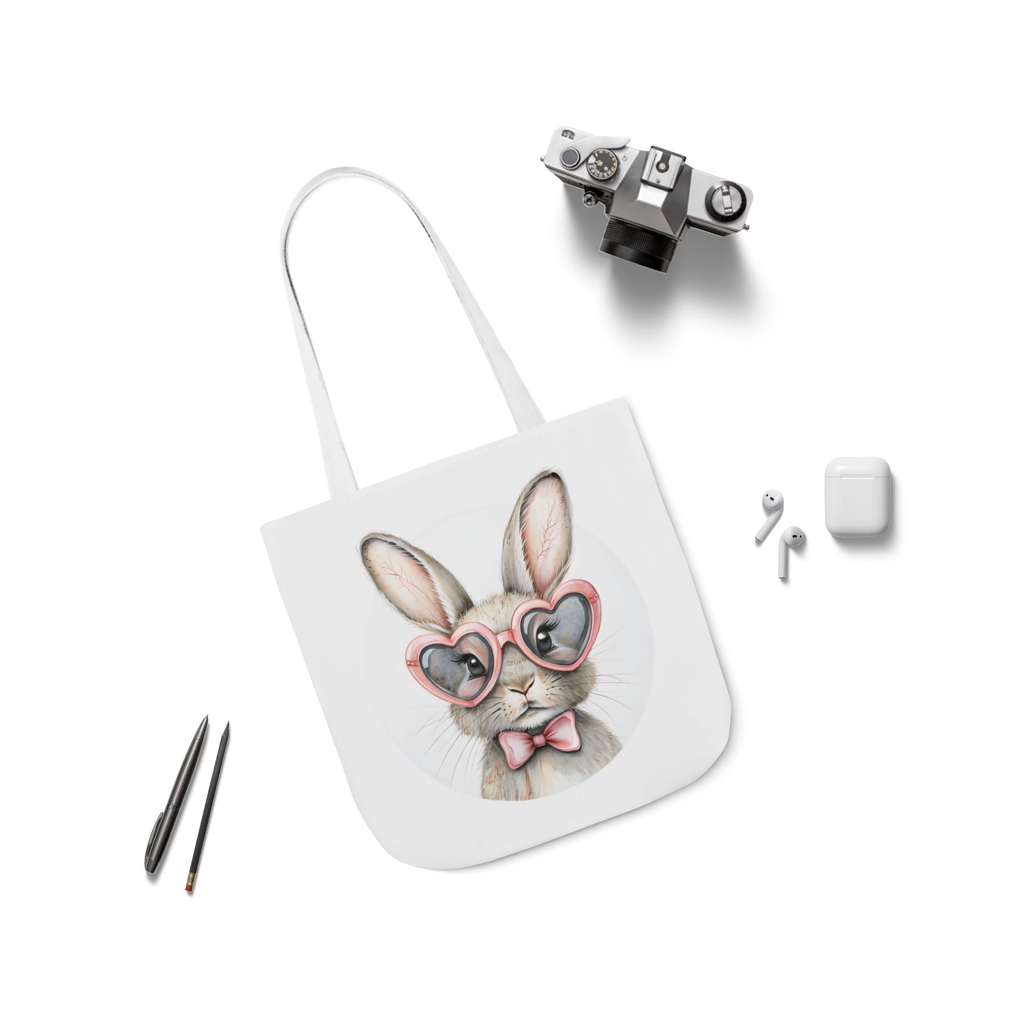 White-strap canvas tote bag with bunny face print and small accessory items shown