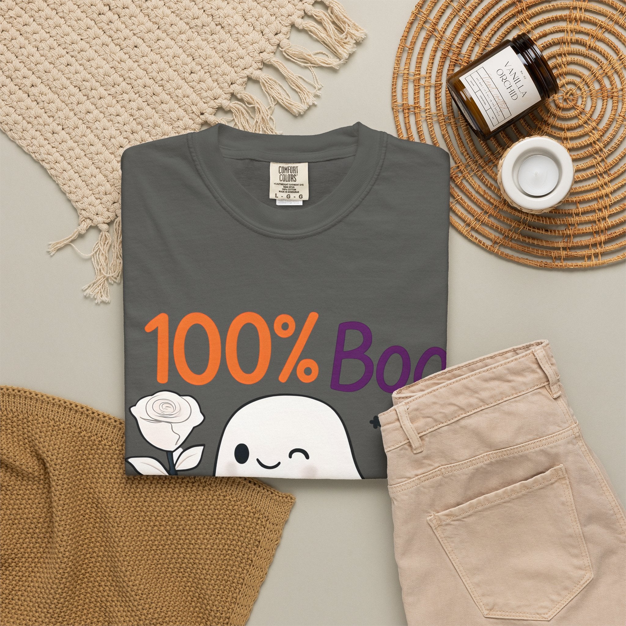 Dark gray t-shirt with '100% Boo' ghost and pumpkin graphic, folded flat lay