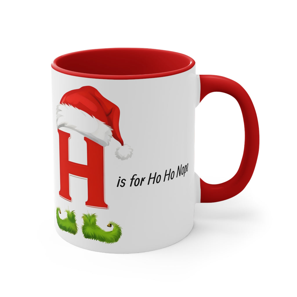 White H mug with Santa hat graphic, red handle, 'is for Ho Ho' text, angled view
