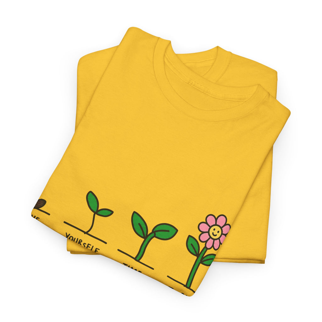 Yellow T-shirt with sprout-and-flower growth graphic, folded and laid flat