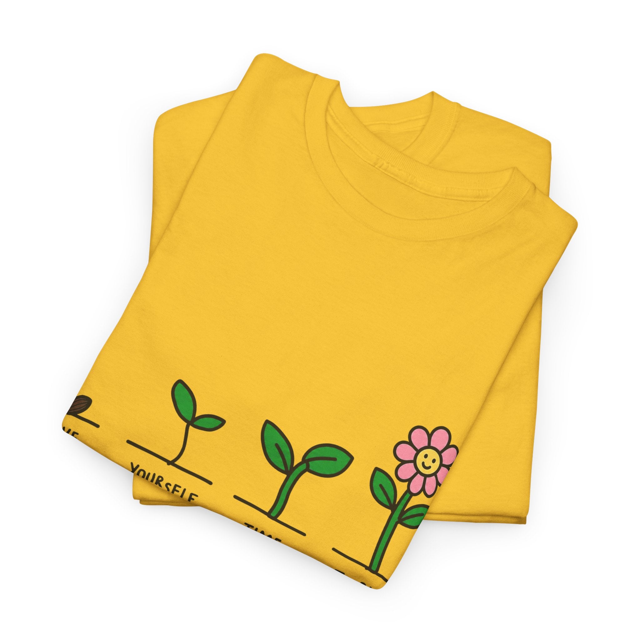 Yellow T-shirt with sprout-and-flower growth graphic, folded and laid flat
