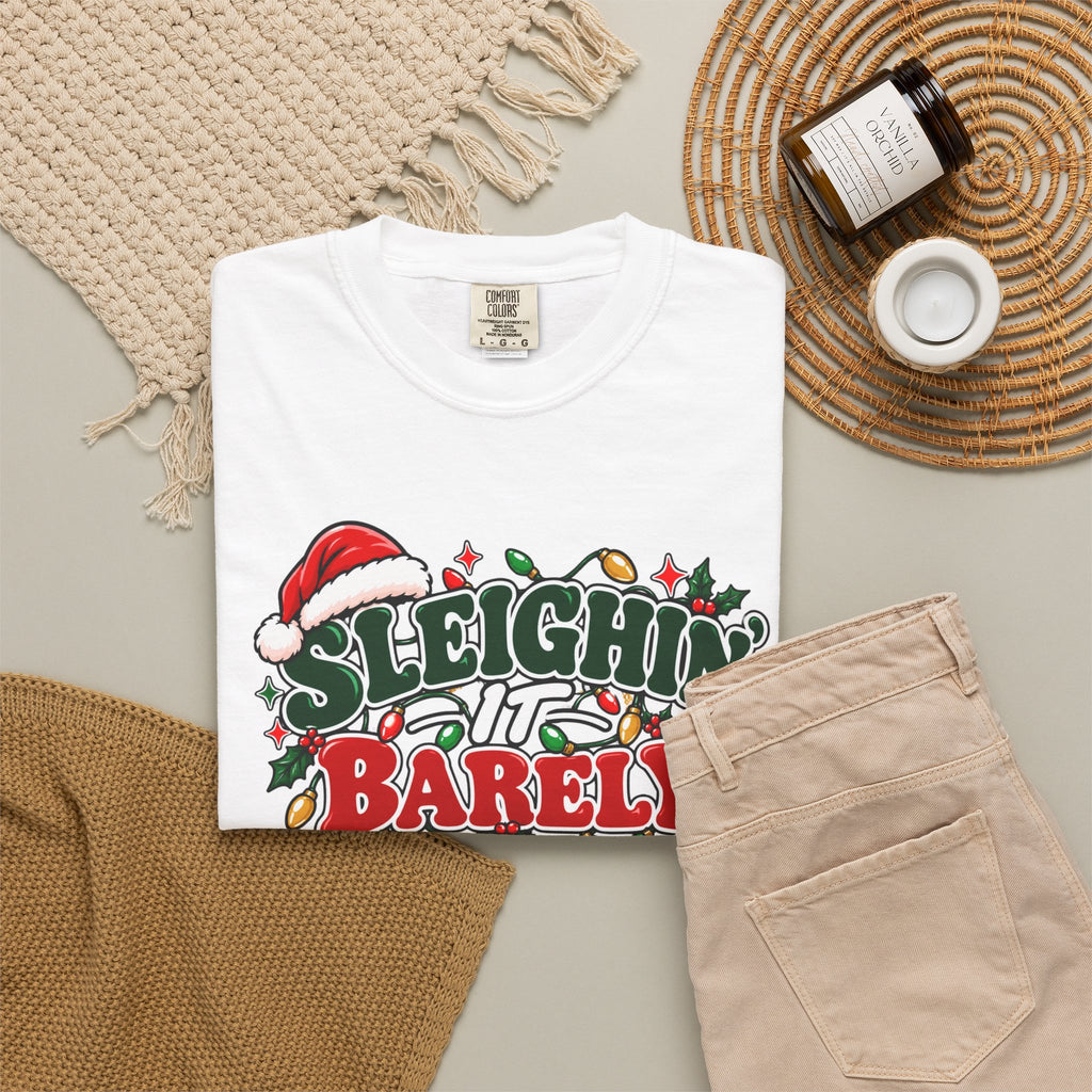 White unisex crewneck Christmas graphic t-shirt with “Sleighin’ it Barely” front print