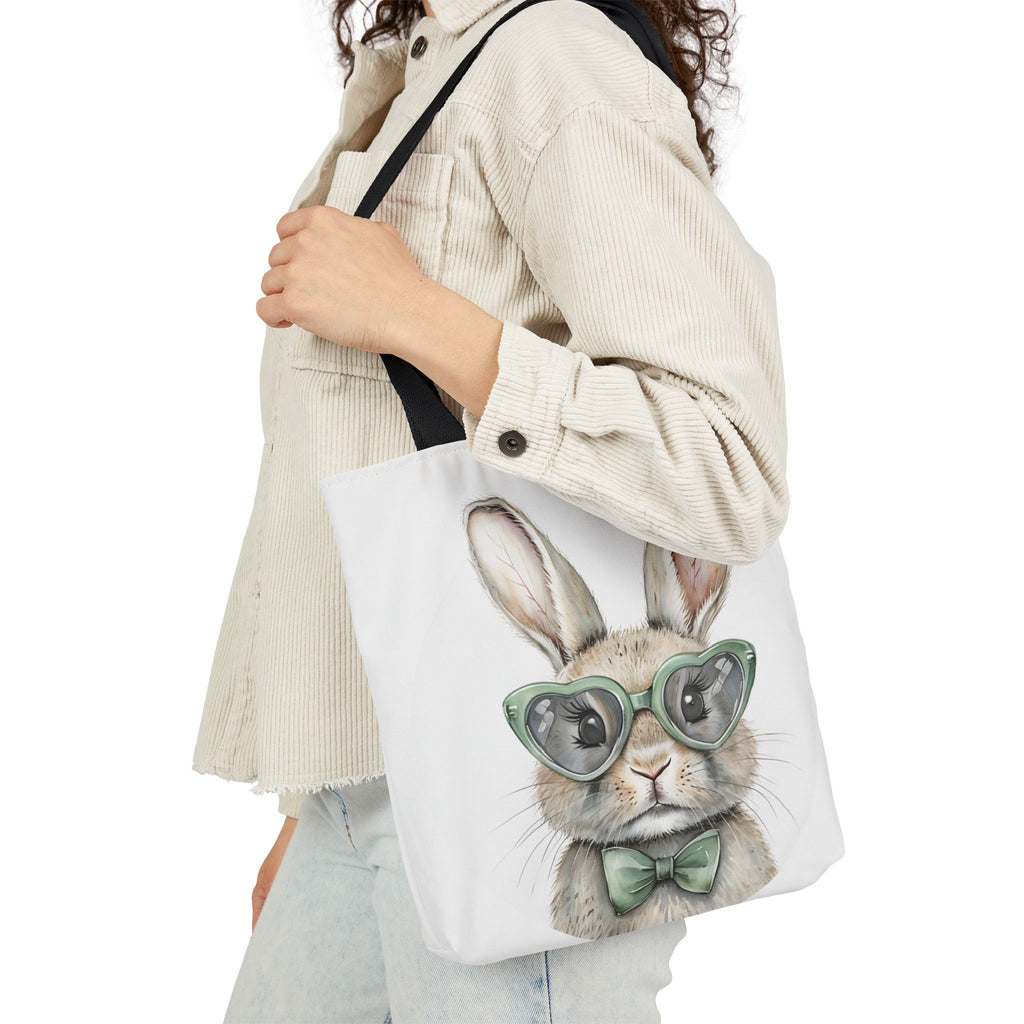 White canvas tote bag with bunny face wearing green glasses and bow, side view
