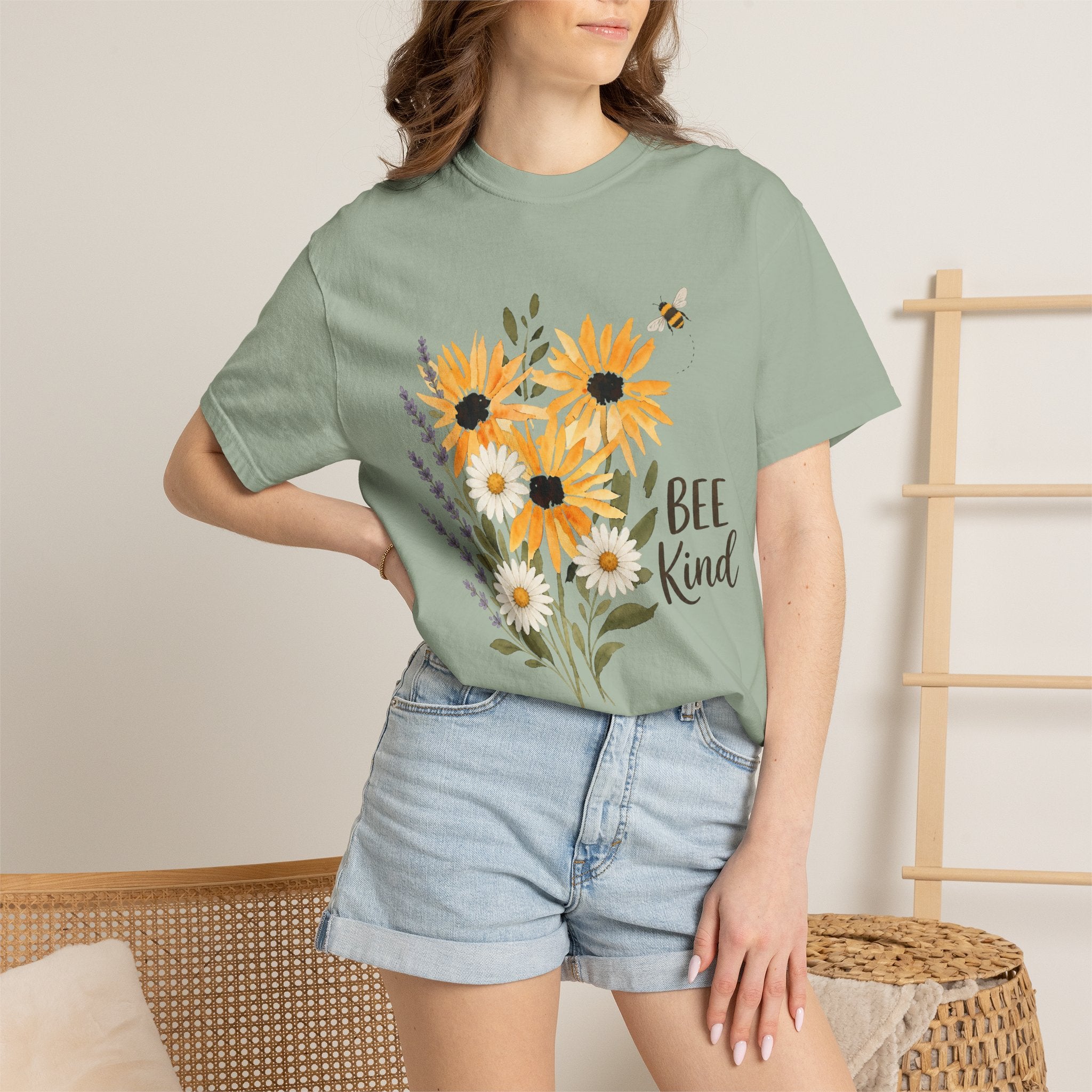 Sage green t-shirt on model with sunflower and lavender bouquet bee graphic