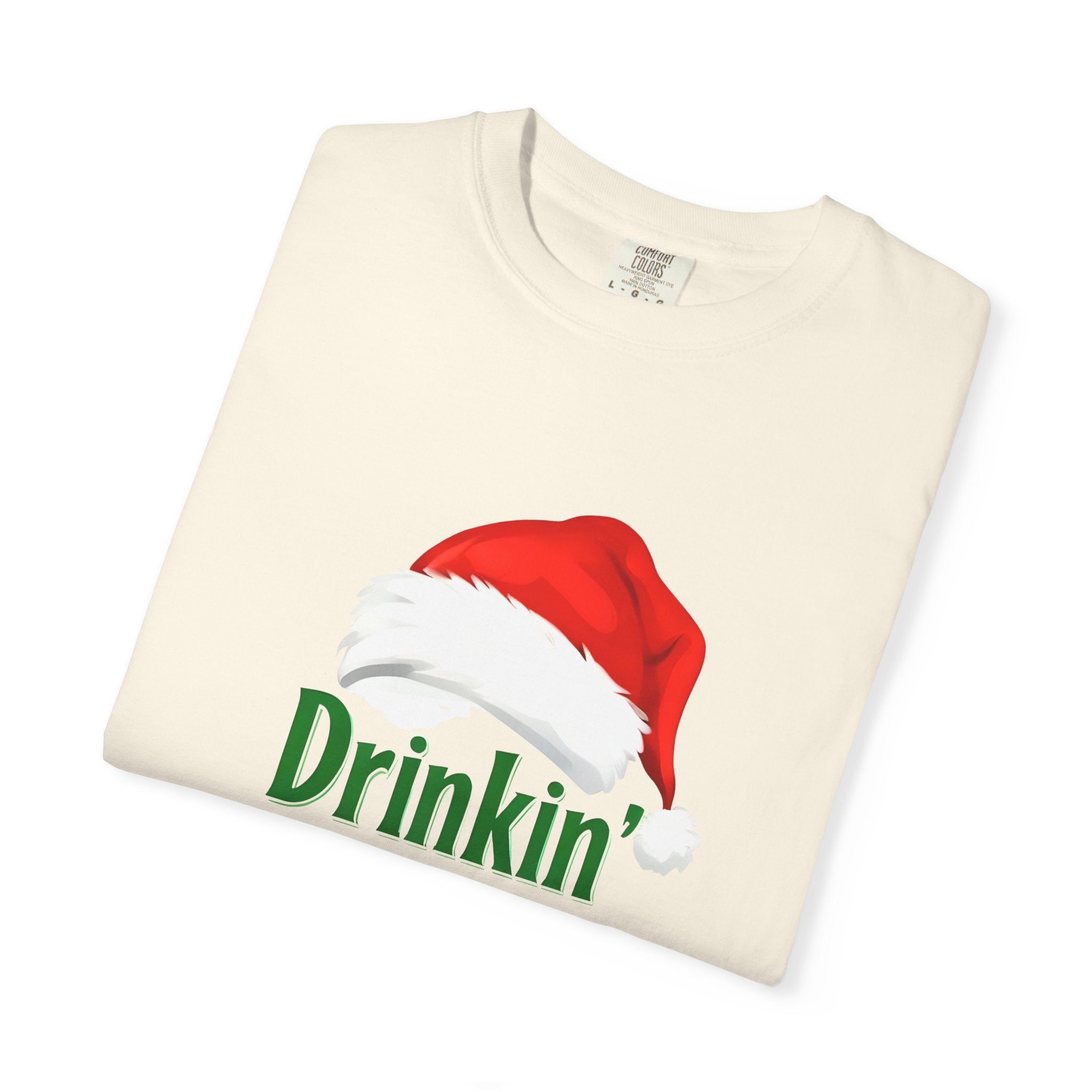 Cream t-shirt with red Santa hat and green “Drinkin’” text graphic