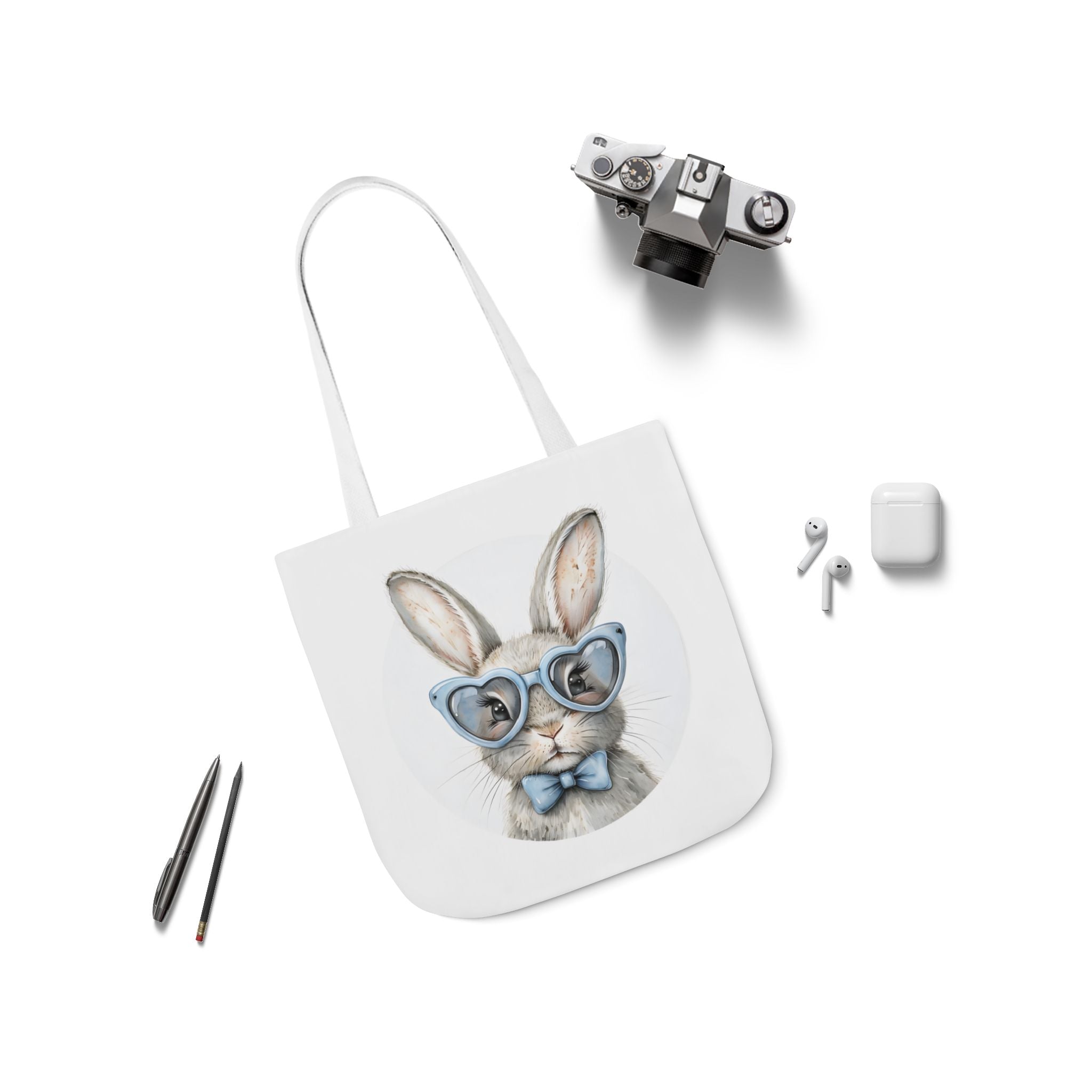 Bunny canvas tote bag with rabbit face graphic, white straps laid flat