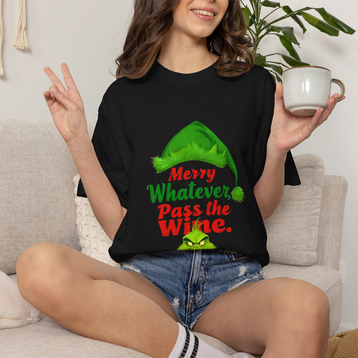 Black crew-neck tee on model with green elf graphic and "Merry Whatever Pass the Wine" print