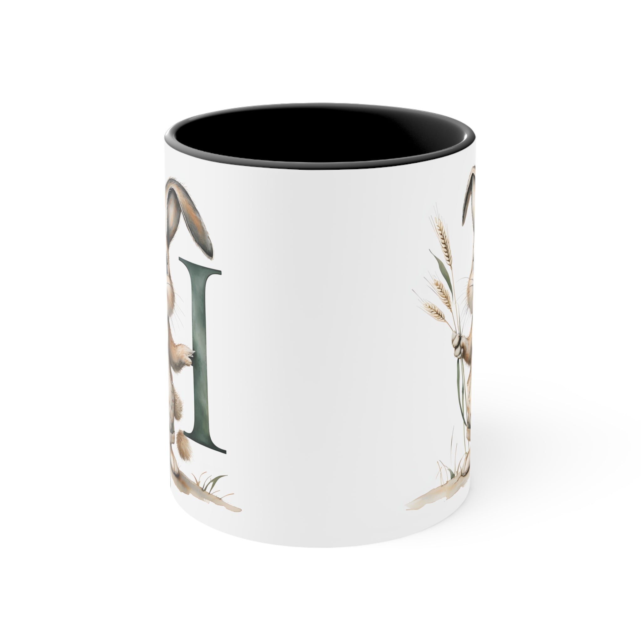 White mug with black rim, bunny and letter I illustration on the side