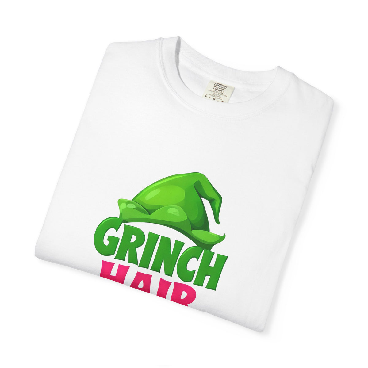 White graphic t-shirt with green character “GRINCH” and “Hair Don’t Care” print
