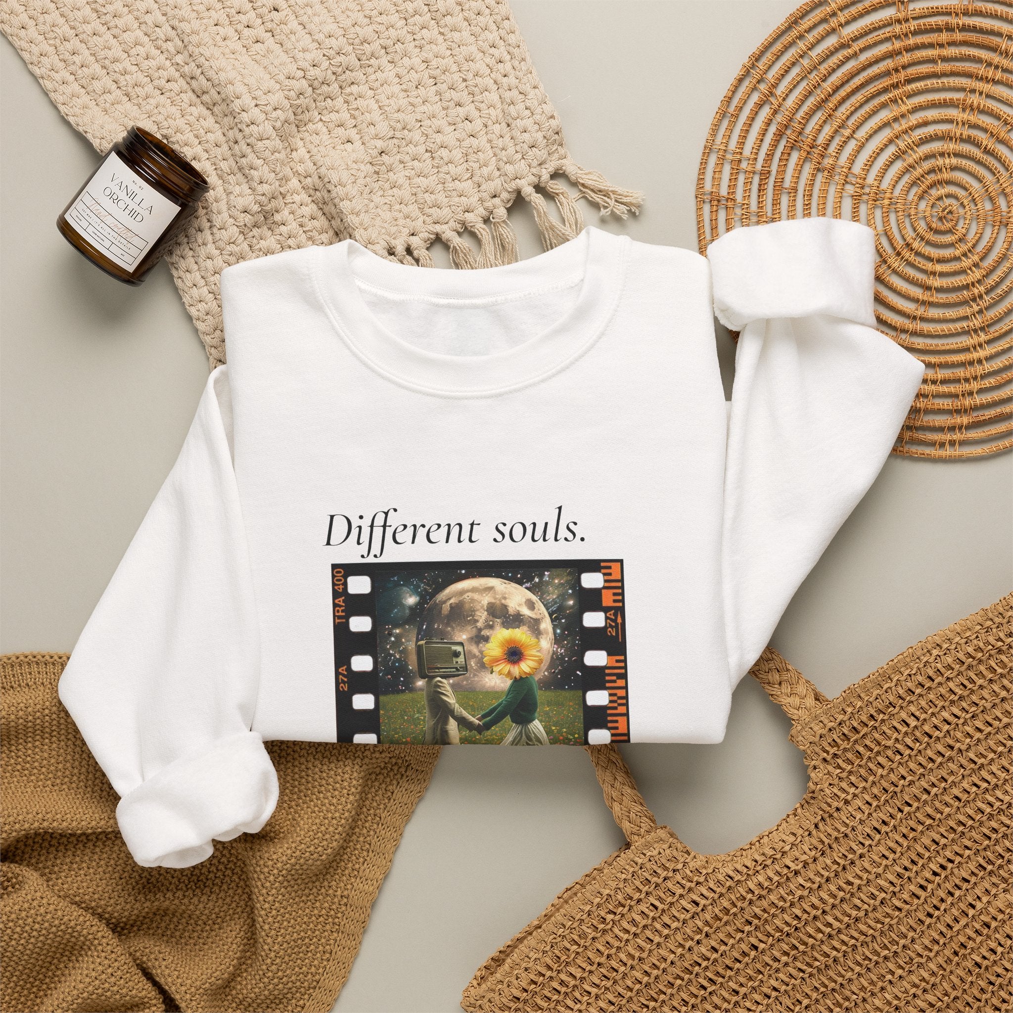 White crewneck sweatshirt with “Different souls.” filmstrip graphic