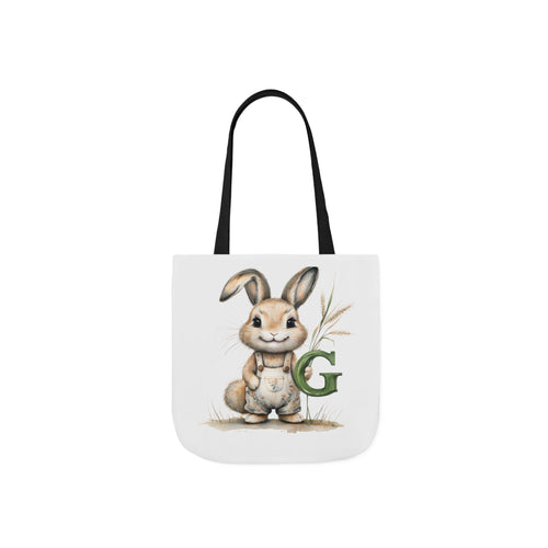 Black canvas tote bag with bunny illustration and green letter G on front