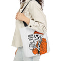 Canvas tote bag, white with black handles; Grim & Tonic Time skeleton in orange coat