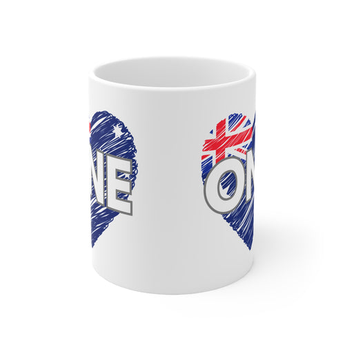 White ceramic coffee mug with two blue heart halves and the word ONE