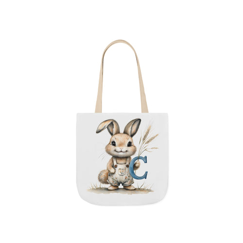 Beige canvas tote bag with bunny and letter C graphic, fabric handles