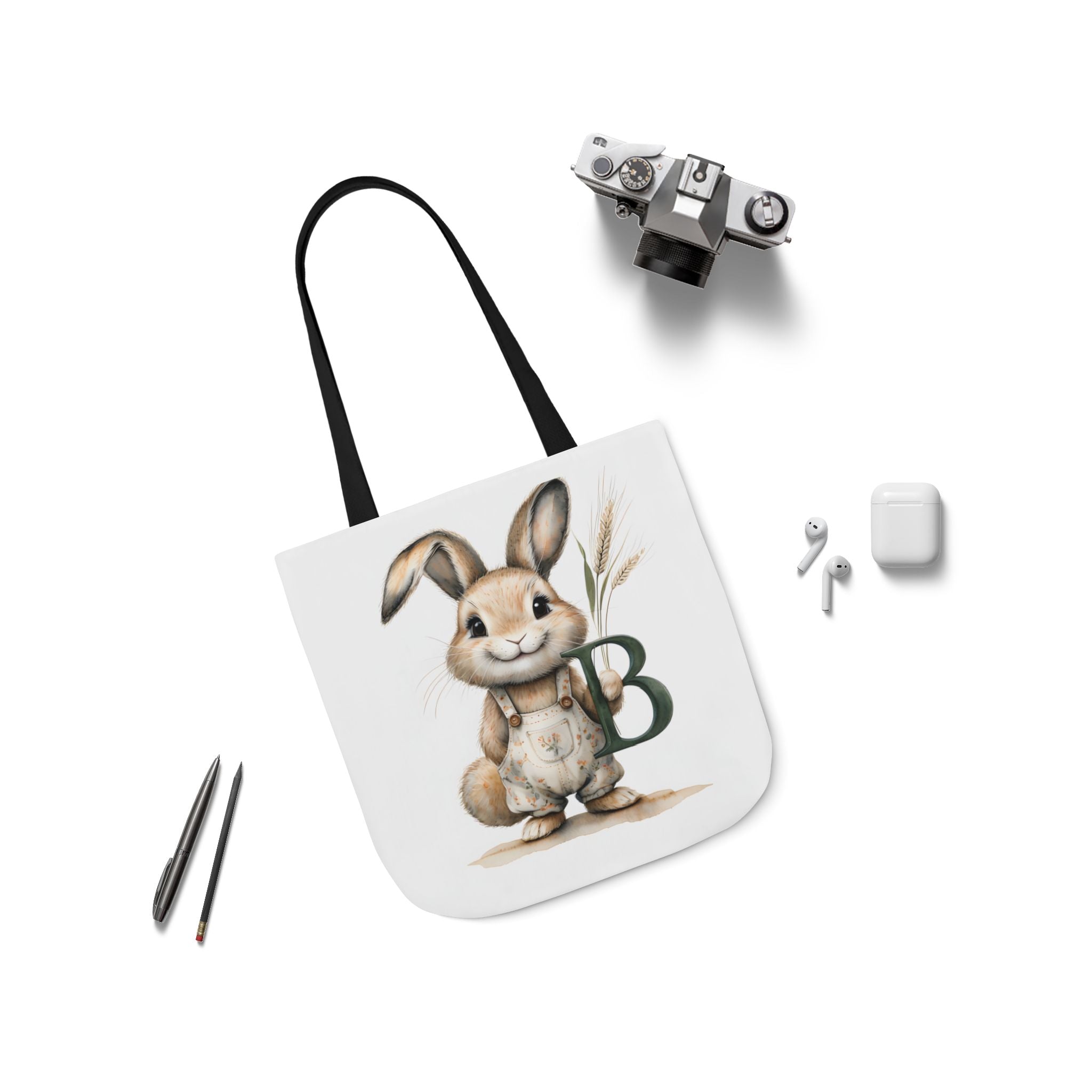 Canvas tote bag with bunny graphic and green letter B, black straps
