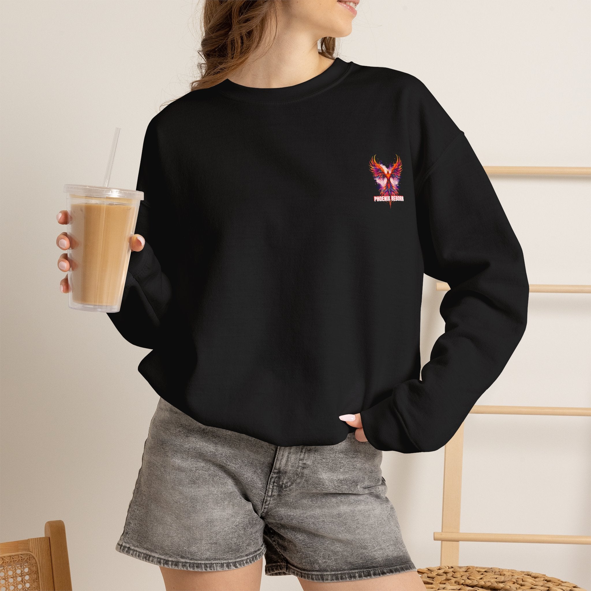 Black crewneck sweatshirt with small phoenix bird graphic on chest