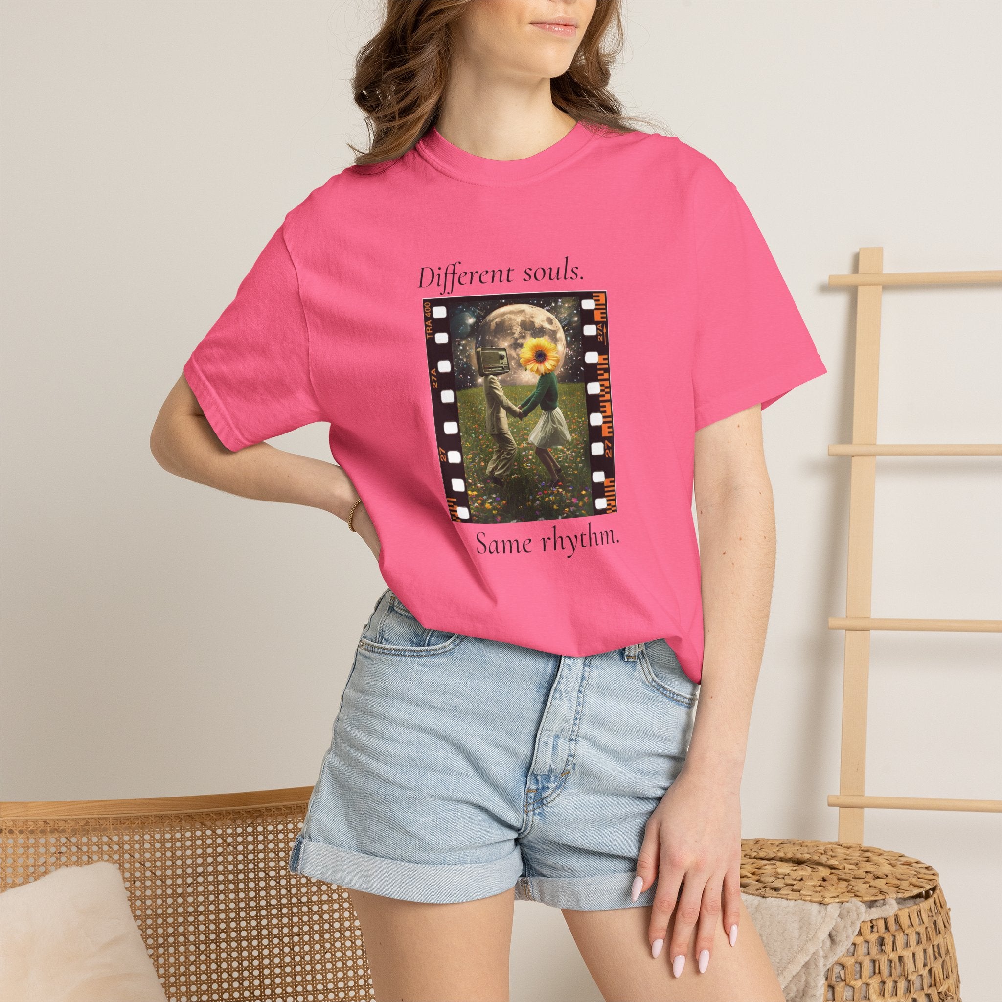 Pink crewneck graphic tee on model, movie-frame artwork with flower