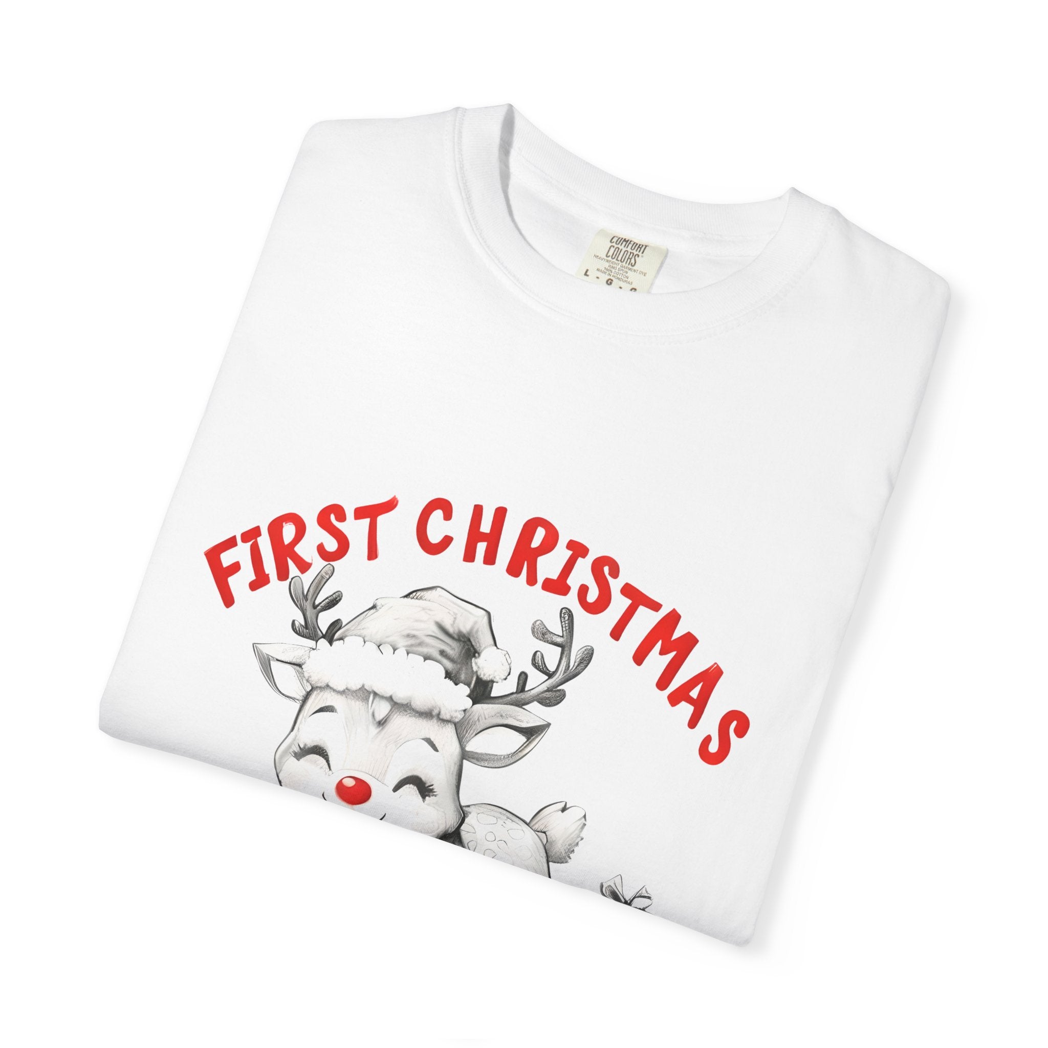 White T-shirt close-up: reindeer graphic with red "FIRST CHRISTMAS" text and "2025"