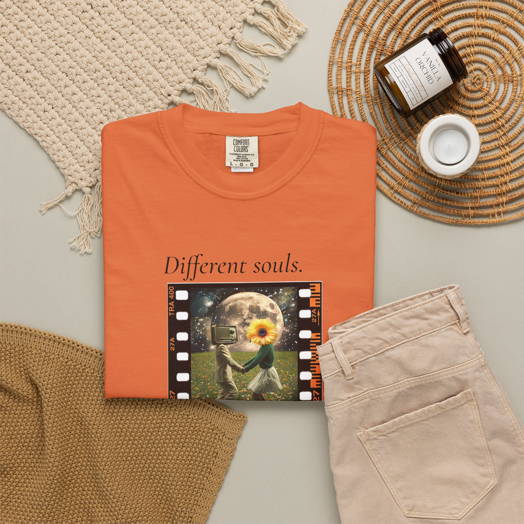 Orange crew-neck short-sleeve tee, folded, featuring filmstrip sunflower graphic